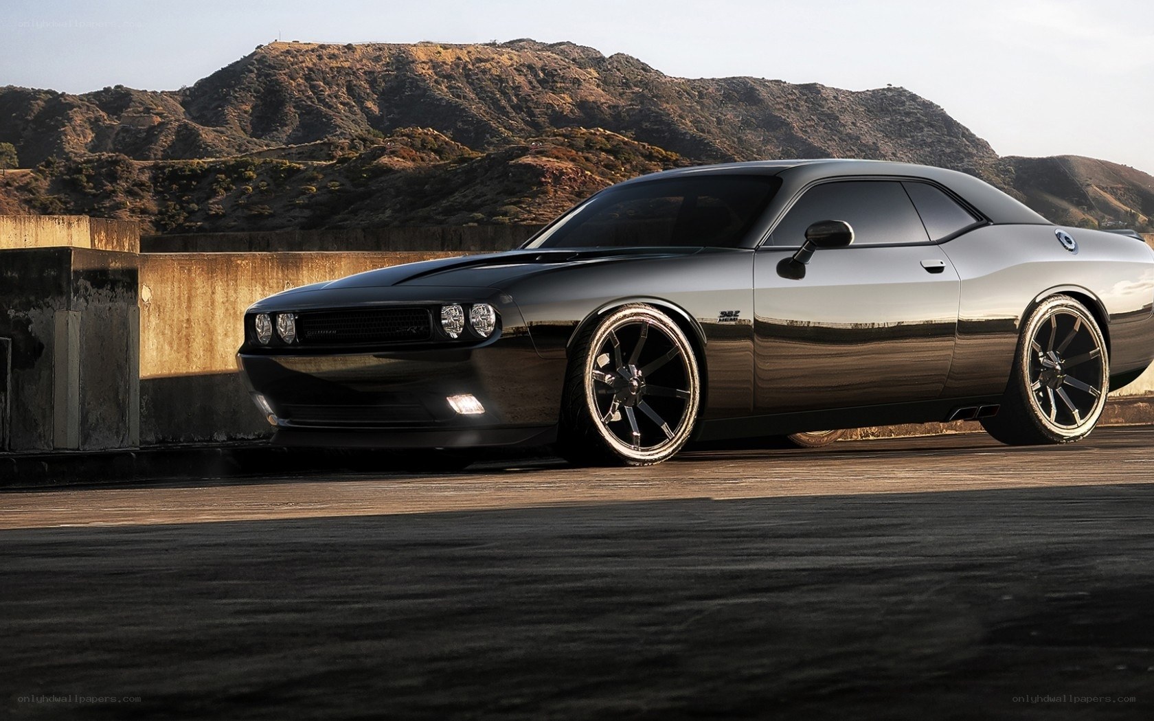Black muscle car on a bridge