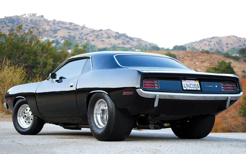 Black muscle car on a hillside