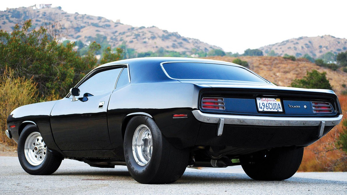 Black muscle car on a hillside