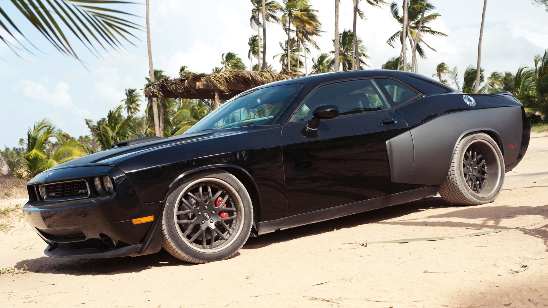 Black muscle car on beach