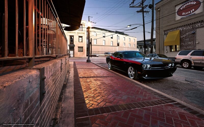 Black muscle car on city street