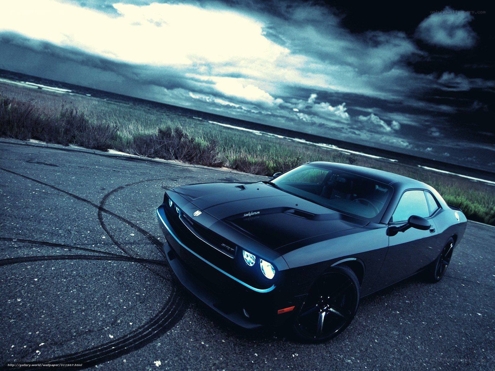 Black muscle car on coastal road