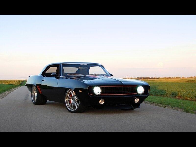 Black muscle car on country road