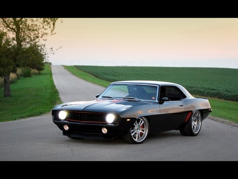Black muscle car on country road