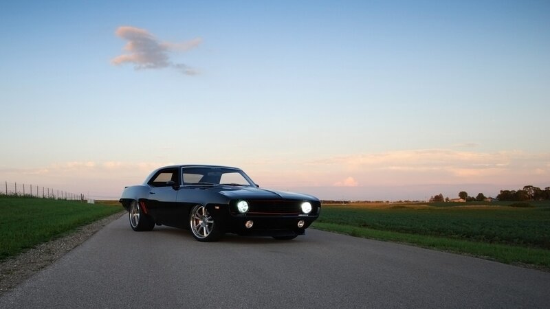 Black muscle car on country road