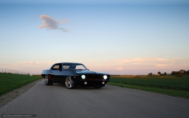Black muscle car on country road