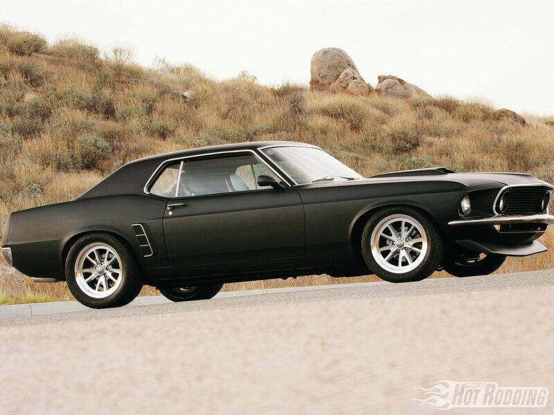 Black muscle car on desert road