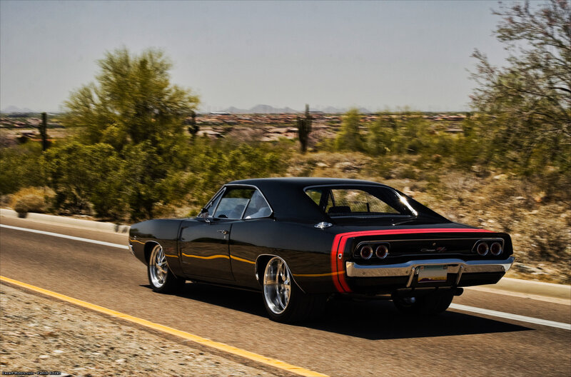 Black muscle car on desert road