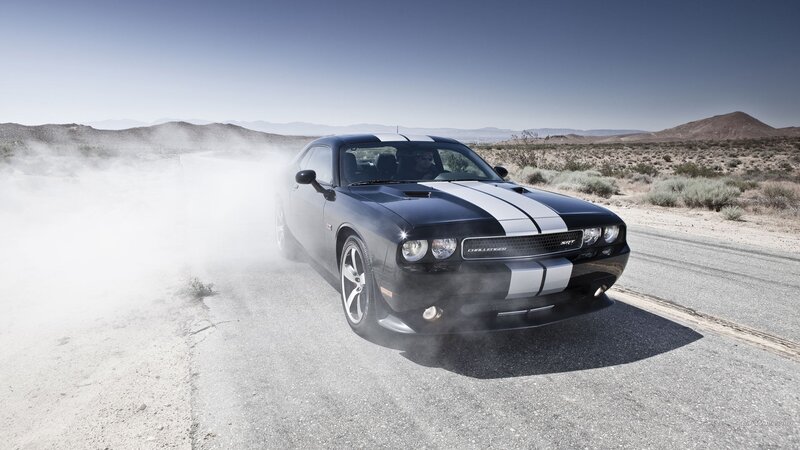 Black muscle car on desert road