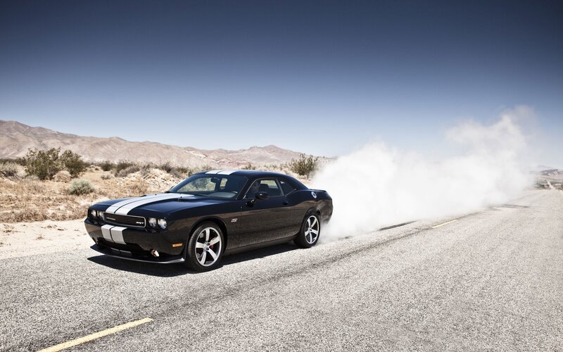 Black muscle car on desert road