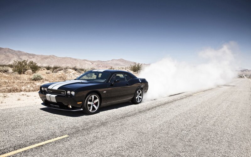 Black muscle car on desert road