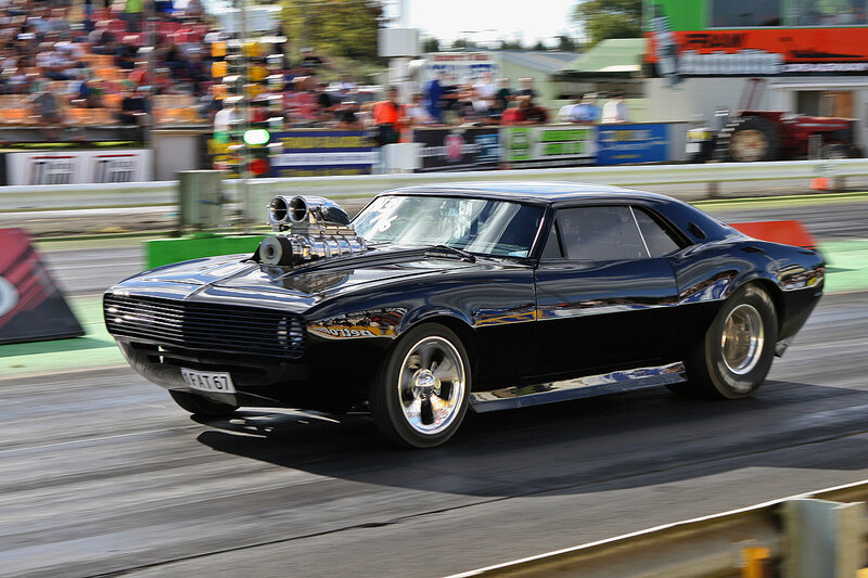 Black muscle car on drag strip