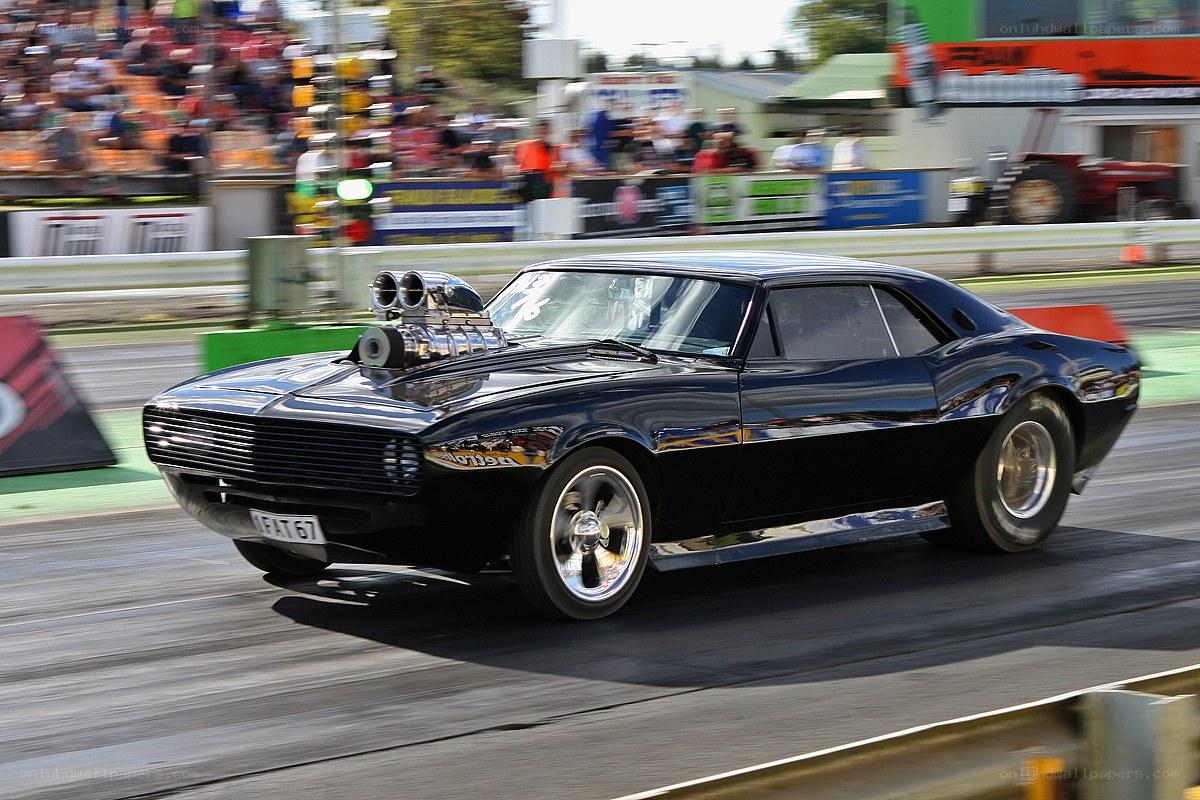 Black muscle car on drag strip