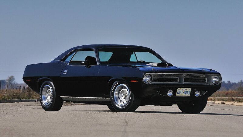Black muscle car on pavement