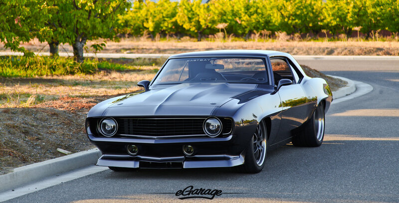 Black muscle car on road