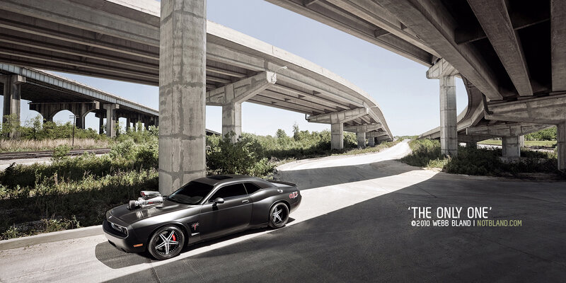 Black muscle car under highway