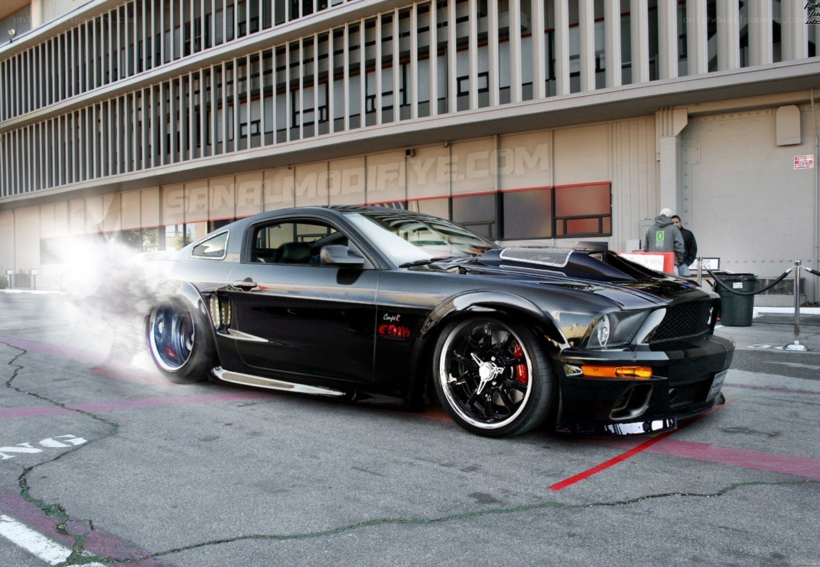 black mustang doing burnout