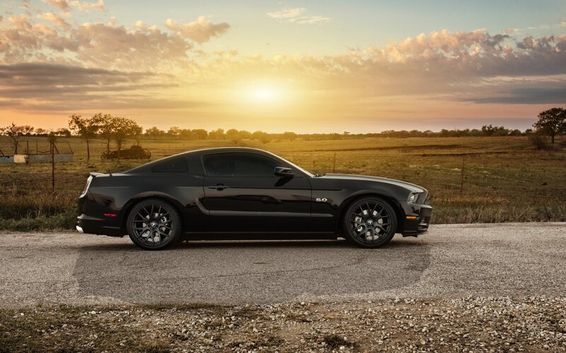 Black Mustang on a country road