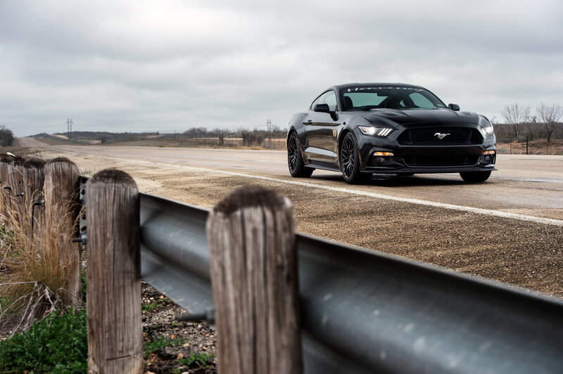 Black Mustang on a rural road