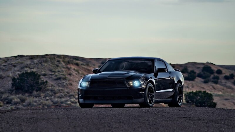 black mustang on desert road