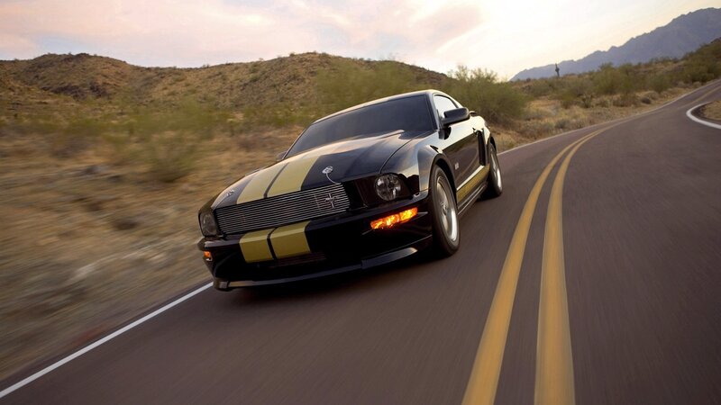 black mustang on desert road