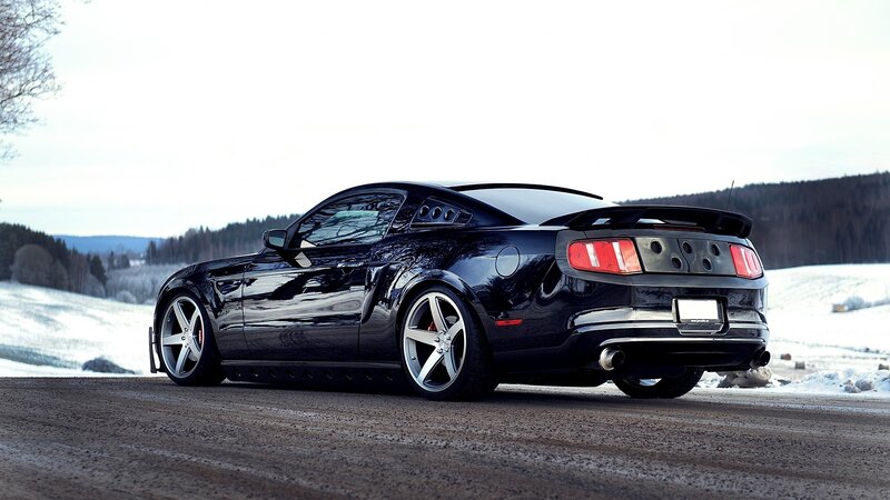 black mustang on snowy road
