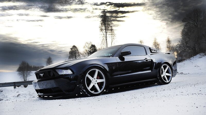 Black Mustang on snowy road