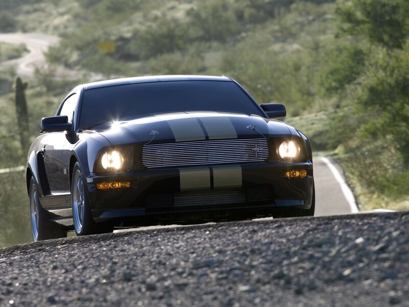 black mustang on winding road