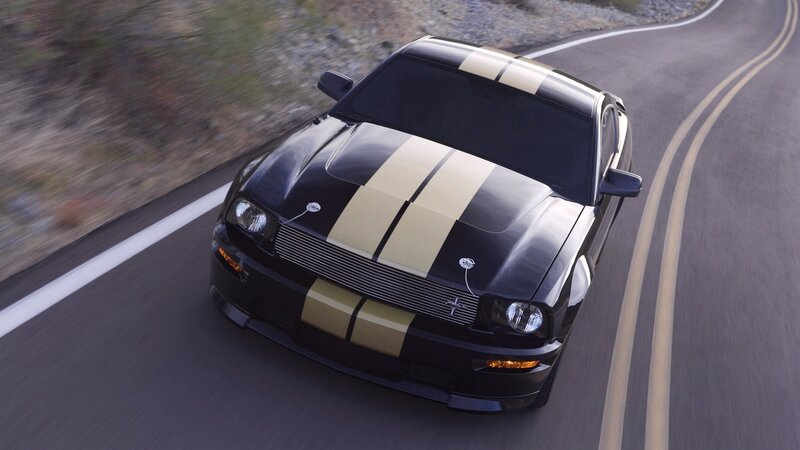 black mustang on winding road
