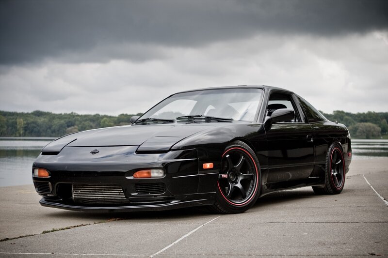 Black Nissan 180SX on a lake