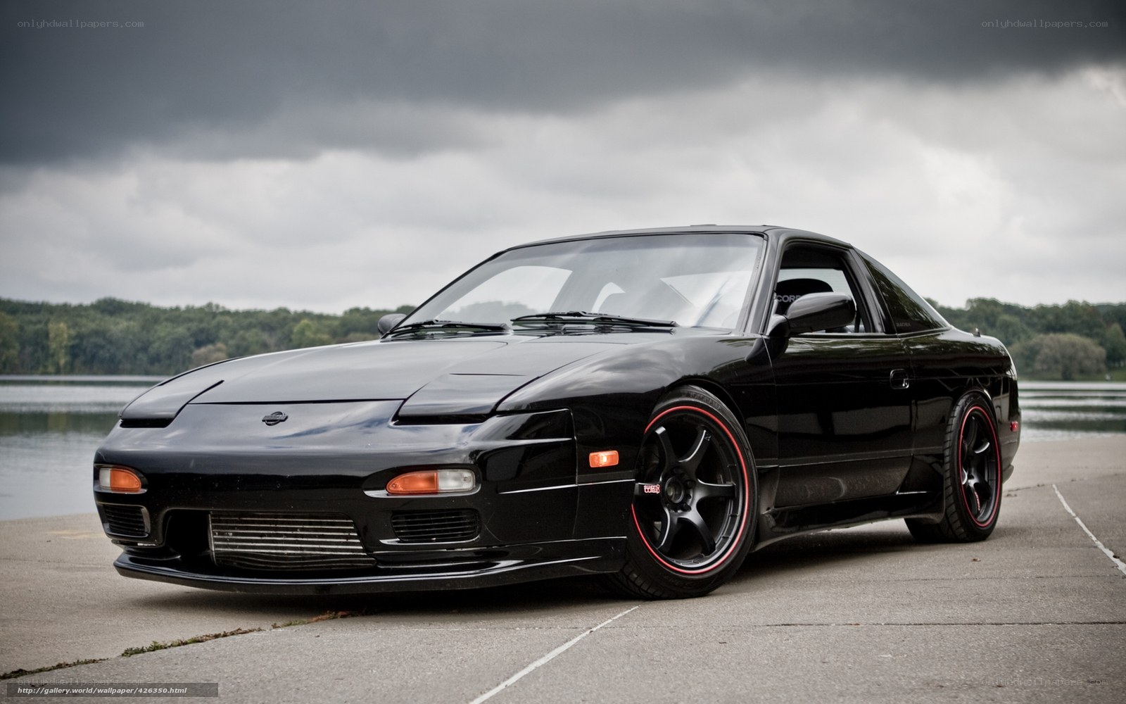 Black Nissan 180SX on a lake