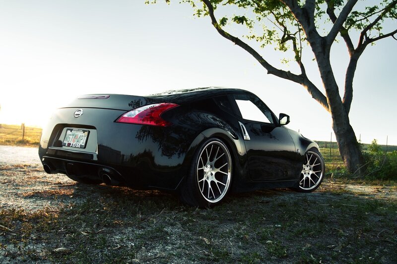 black nissan 370z by a tree
