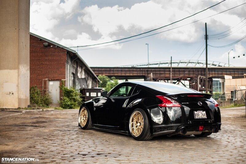 black nissan 370z on cobblestones