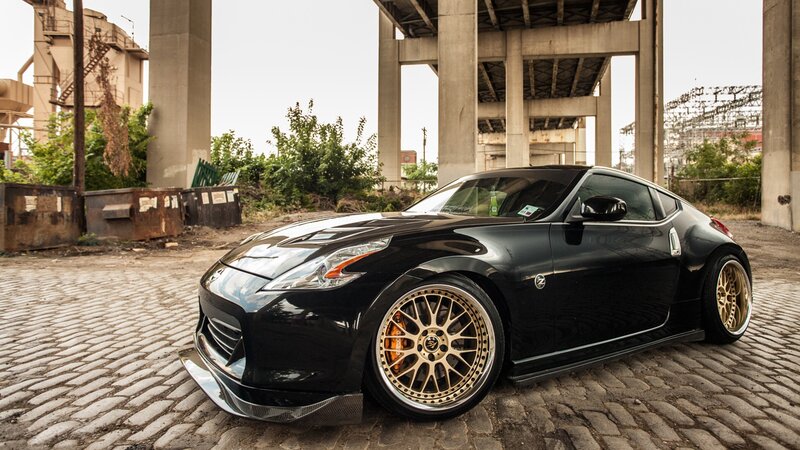 black nissan 370z on cobblestones