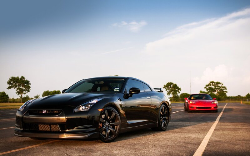 Black Nissan GT-R and red Corvette