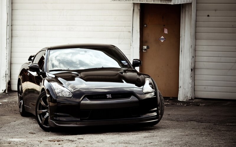 Black Nissan GT-R in front of garage