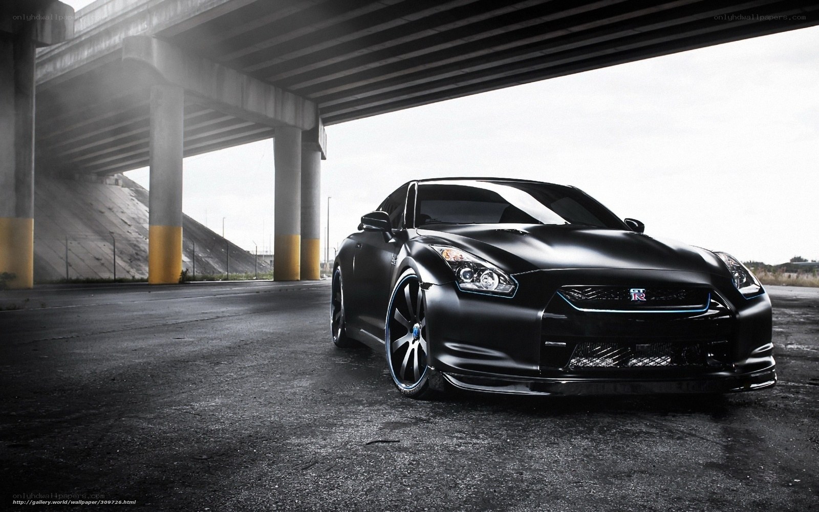 Black Nissan GT-R under overpass