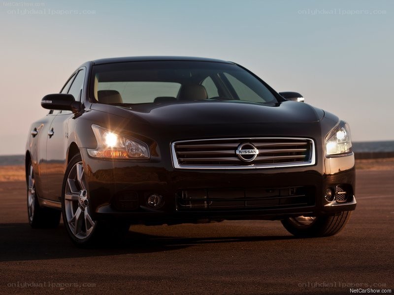 Black Nissan Maxima at sunset