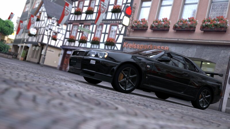 Black Nissan Skyline on cobblestone street