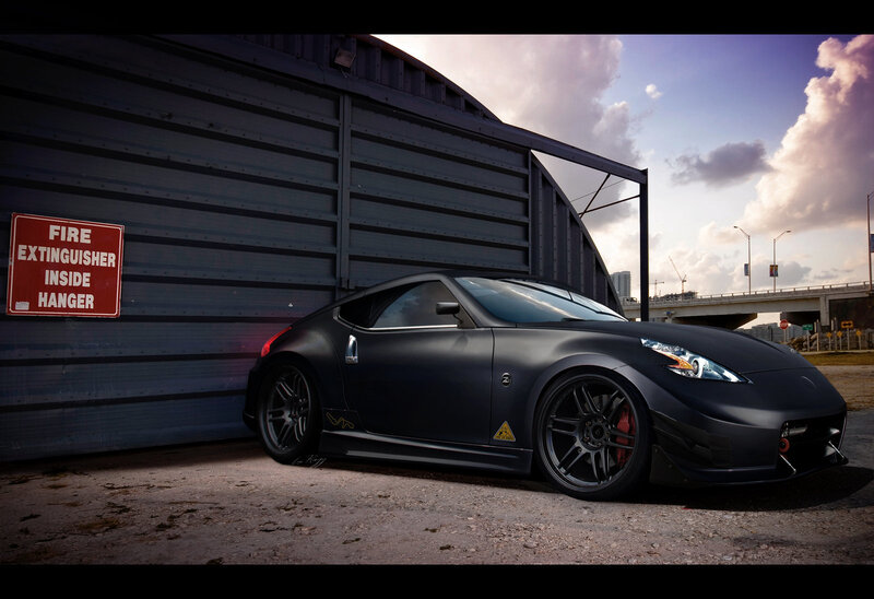 Black Nissan sports car in hangar