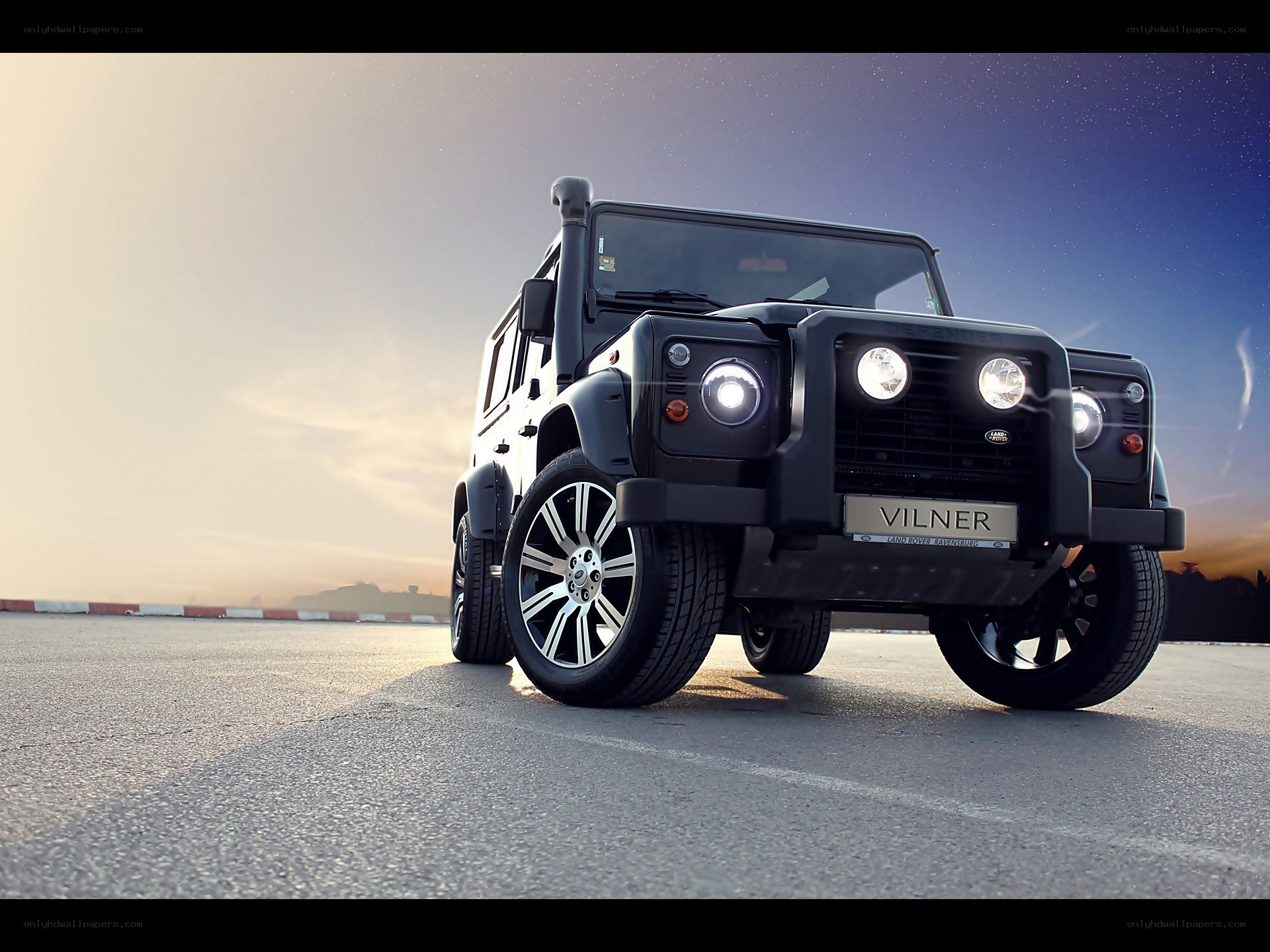Black off-road vehicle at sunset