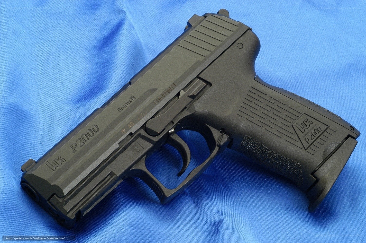Black P2000 pistol on blue