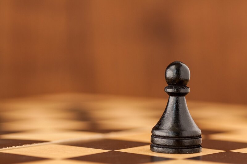 Black pawn on chessboard