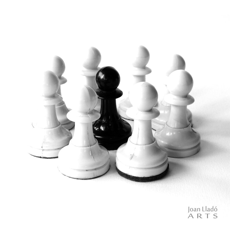 Black Pawn Surrounded by White Pawns