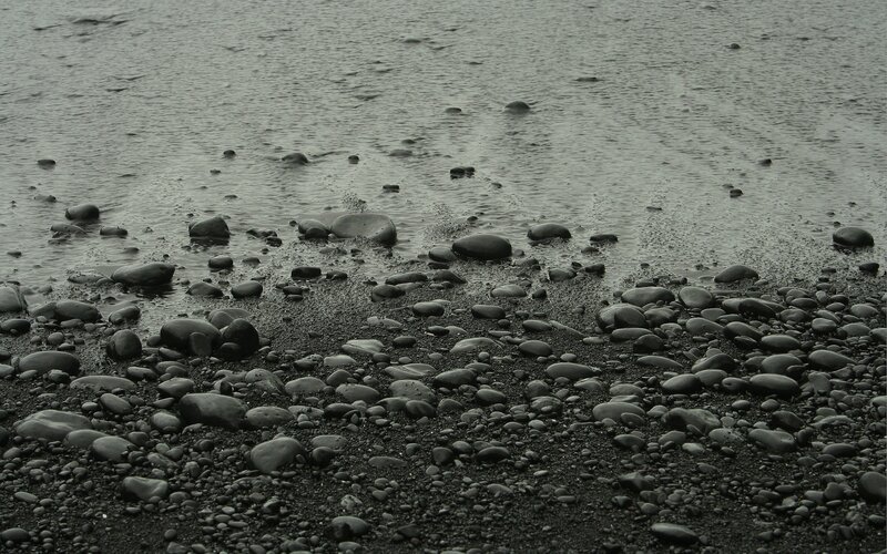 black pebble beach at low tide