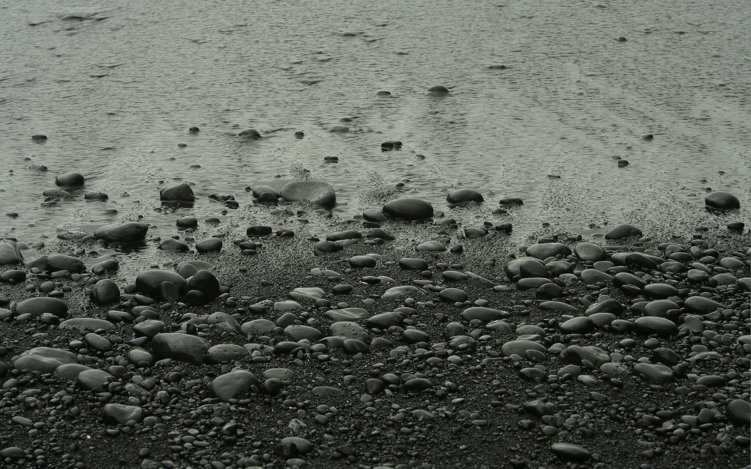 black pebble beach at low tide