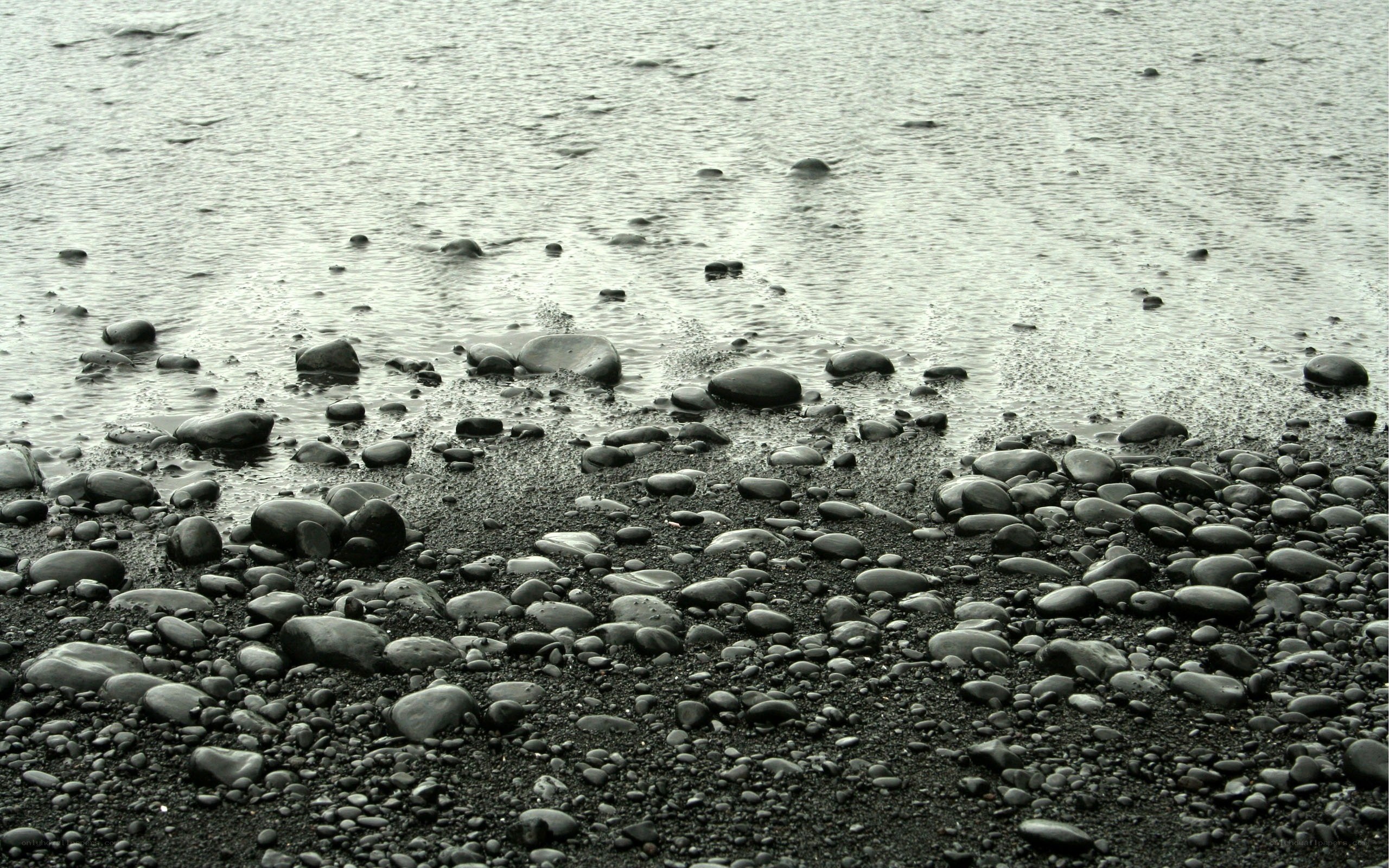 black pebble beach at low tide