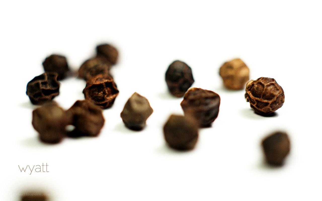 black peppercorns on white