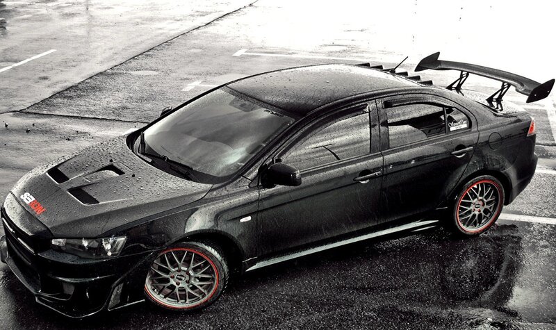 Black Performance Car — Dramatic, Photograph, Wet Pavement