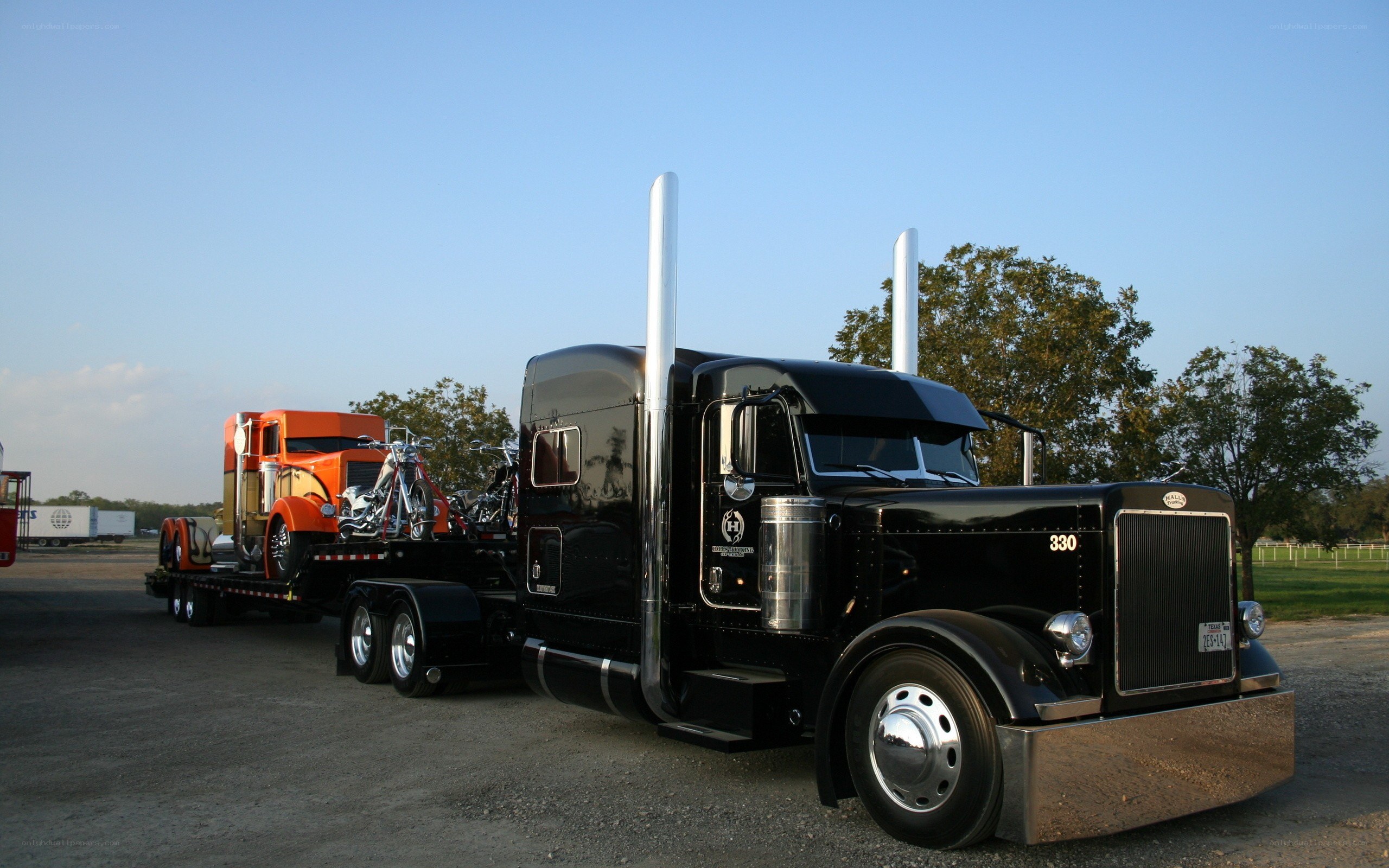 Black Peterbilt truck with trailer